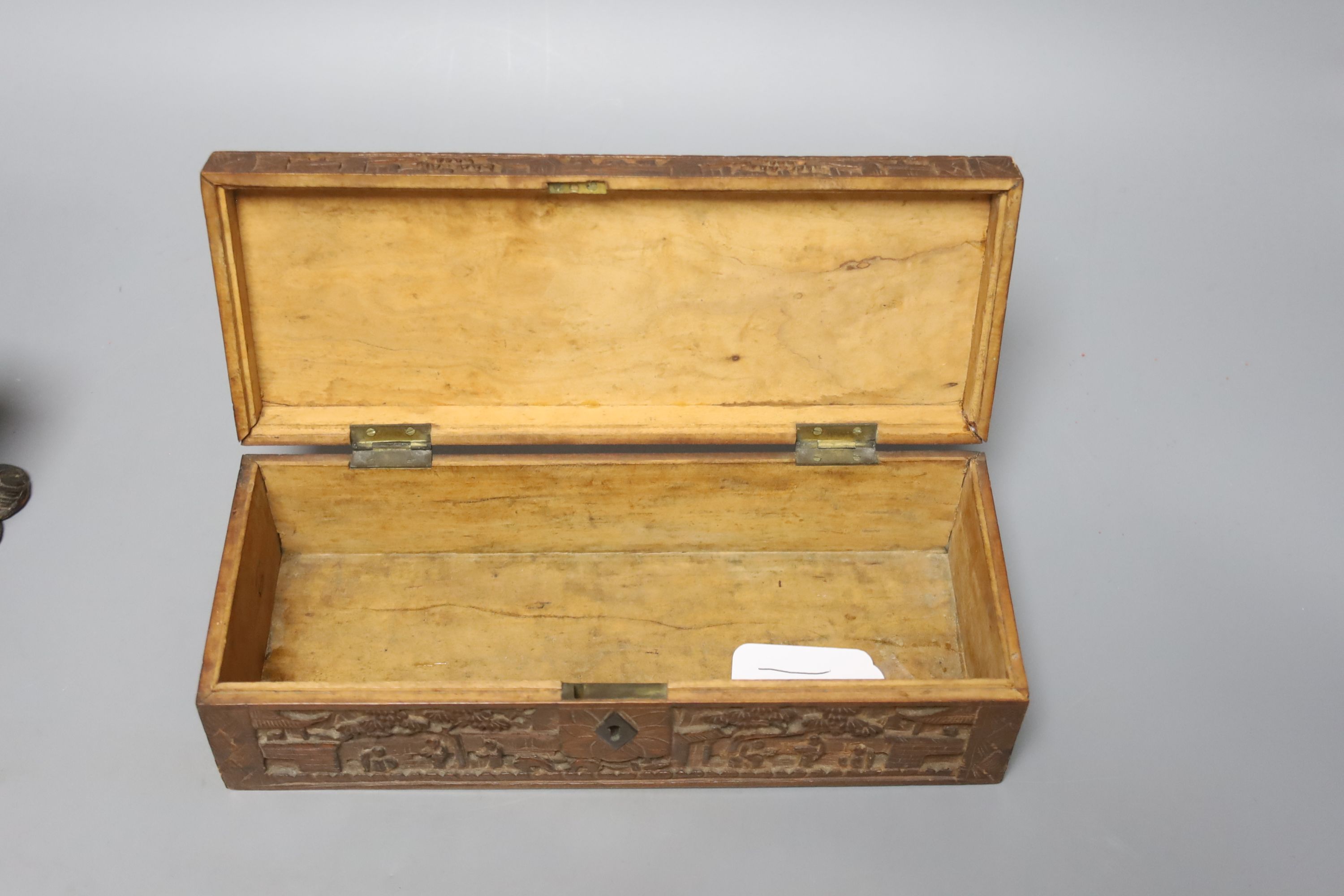 Two 19th century Chinese carved sandalwood boxes, together with a similar puzzle box, length 27cm